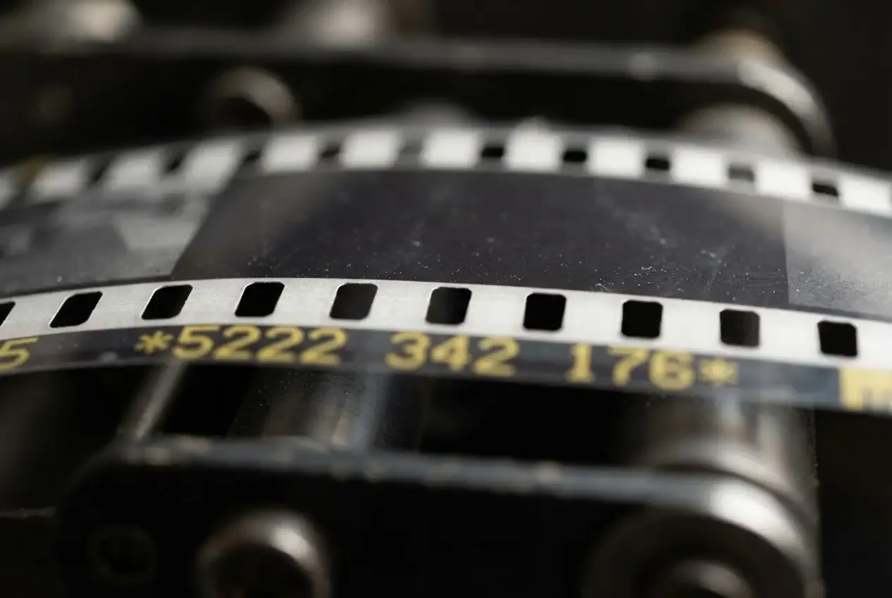 Extreme macro of film sprocket holes, edge numbering out of focus behind